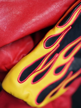 Detail of yellow flame appliqué with red stitching on Billy Bones Club leather jacket sleeve