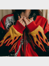 Woman wearing Billy Bones Club black and crimson leather jacket with skeleton palette graphic