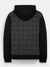 Back view of the black and grey Coach Signature hoodie with monogram print panel