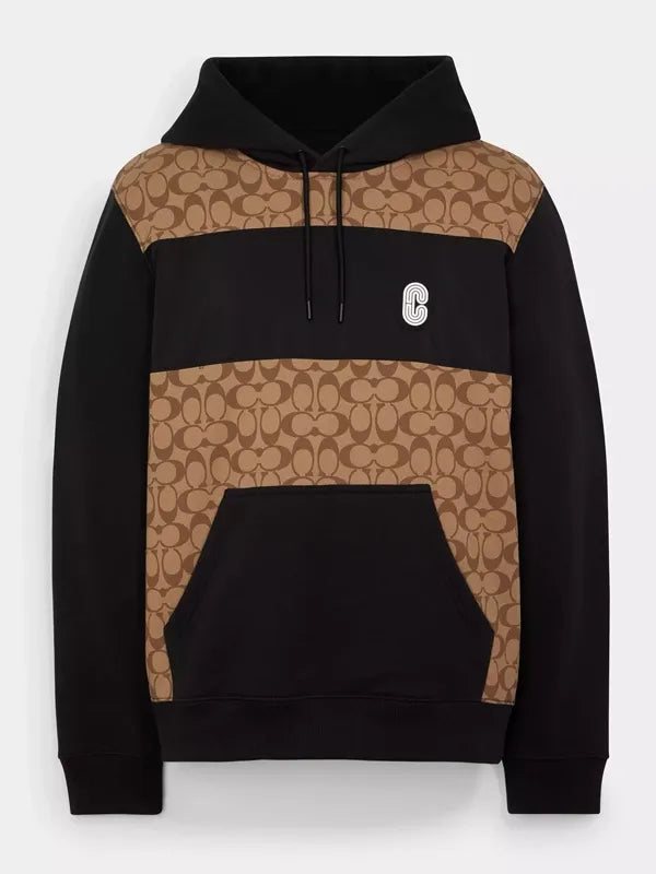 Front view of the black and khaki Coach Signature hoodie with monogram print panels