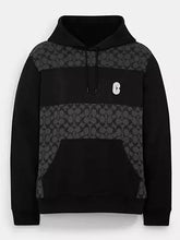 Front view of the black and grey Coach Signature hoodie with logo patch