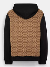 Back view of the black and khaki Coach Signature hoodie showing the full monogram panel