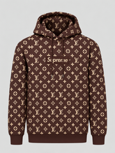 Brown monogram-pattern pullover hoodie featuring a Supreme-style box logo on the front.