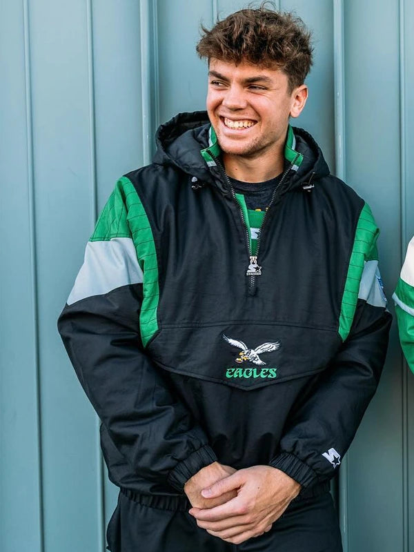 Man smiling wearing Philadelphia Eagles black and green Starter pullover jacket