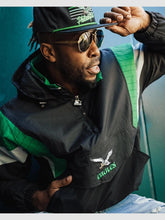 Close-up of Eagles Starter jacket chest logo and half-zip closure