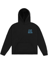 Black fleece hoodie with blurred long-exposure graphic of Zach Bryan playing an acoustic guitar printed on the back