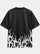 Back view of oversized black t-shirt featuring white flame graphic with hidden lettering