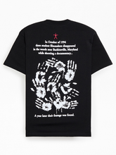Back view of black Blair Witch t-shirt featuring eerie handprint graphic and 1994 Burkittsville story text