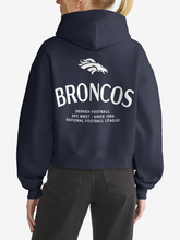 Back view of navy Denver Broncos hoodie featuring horse logo and wordmark graphic