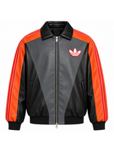 Front view of the Charizard colorway jacket showing the orange stripe trim and trefoil logo.