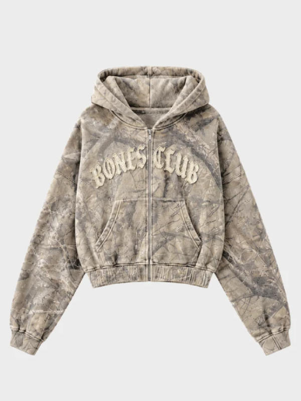 Front view of tan and grey treecamo zip-up hoodie with Bones Club chest logo