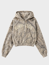 Front view of tan and grey treecamo zip-up hoodie with Bones Club chest logo