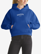Woman wearing royal blue New York Giants foundation hoodie, front view with chest wordmark