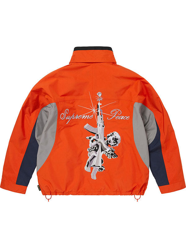 Back view of the orange Supreme Gore-Tex jacket with collar raised, showing the embroidered graphic and drawstring hem.