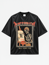 front view of black t-shirt showing skeleton artist painting a skull canvas