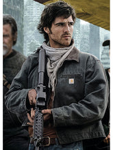 Jacob Elordi as Hig holding a rifle in green canvas Carhartt-style jacket from The Dog Stars