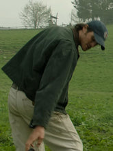 Jacob Elordi walking through a field wearing the Dog Stars Hig jacket