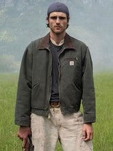 Jacob Elordi in olive green canvas jacket standing in a field, The Dog Stars 2026