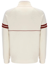 Back view of the cream track jacket showing ribbed hem and stripe detailing