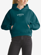 Woman wearing teal Philadelphia Eagles foundation hoodie, front view with chest wordmark