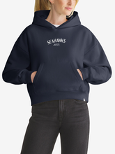 Woman wearing navy Seattle Seahawks foundation hoodie, front view with chest wordmark
