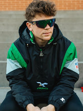 Man wearing vintage 90s Philadelphia Eagles Starter black half-zip pullover jacket front view