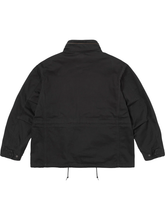 Back view of the black field jacket showing the drawcord hem and clean silhouette.