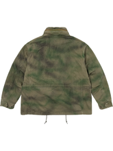 Back view of the green tie-dye field jacket showing the drawcord hem and mottled dye pattern.