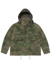 Front view of the green tie-dye field jacket with the removable hood attached and up.