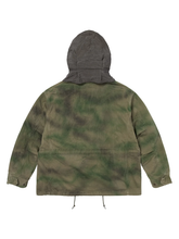 Back view of the green tie-dye field jacket with the hood attached, showing the contrast hood fabric.