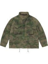 Front view of the green tie-dye M65 field jacket showing the flap pockets and stand collar.