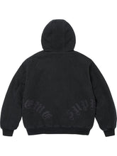 Black washed cotton hooded jacket shown from the back with dark leather appliqué lettering, stitched panels and ribbed hem.