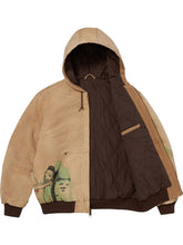 Tan hooded jacket shown open, revealing the quilted nylon interior lining and ribbed hem.
