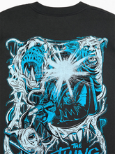 Close-up of black t-shirt front print showing The Thing logo, tagline, and pink melting face graphic