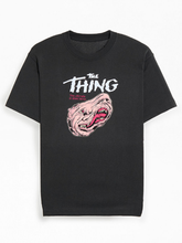 Front view of black t-shirt with The Thing movie logo and melting face graphic